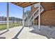 Covered patio with stairs leading to the yard and water offers a relaxing space with views of the backyard at 205 Castlewood Rd, Tyrone, GA 30290