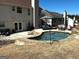 Backyard featuring a swimming pool, a patio with outdoor furniture, and a well-maintained lawn at 4683 Derby Loop, Fairburn, GA 30213