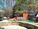 Enjoy this backyard oasis with a pool, waterfall feature and outdoor seating area at 4683 Derby Loop, Fairburn, GA 30213