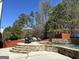 Enjoy outdoor living with this home's pool, complete with stone patio and comfortable seating areas at 4683 Derby Loop, Fairburn, GA 30213