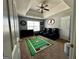 Bedroom featuring themed area rug, fan, tray ceilings and four leather reclining chairs at 4683 Derby Loop, Fairburn, GA 30213