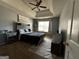 Cozy bedroom featuring a tray ceiling, ceiling fan, and natural light at 4683 Derby Loop, Fairburn, GA 30213