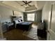 Cozy bedroom featuring a tray ceiling, ceiling fan, and natural light at 4683 Derby Loop, Fairburn, GA 30213