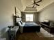Cozy bedroom featuring a tray ceiling, ceiling fan, and natural light at 4683 Derby Loop, Fairburn, GA 30213