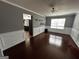 Bright dining room with hardwood floors, neutral paint, and an open view into the kitchen at 4683 Derby Loop, Fairburn, GA 30213