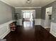 Elegant dining room featuring hardwood floors, decorative molding, and views of the backyard at 4683 Derby Loop, Fairburn, GA 30213