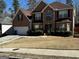 Charming brick two-story home with arched window over front door and well-maintained lawn at 4683 Derby Loop, Fairburn, GA 30213