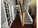 Bright foyer features hardwood floors, gray walls, with staircase and white french doors at 4683 Derby Loop, Fairburn, GA 30213