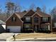 Charming brick two-story home features a manicured front yard, attached garage, and welcoming entrance at 4683 Derby Loop, Fairburn, GA 30213