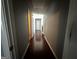 Inviting hallway with hardwood floors, neutral paint, and doors leading to other rooms at 4683 Derby Loop, Fairburn, GA 30213