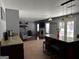 Open kitchen featuring tile floors, granite countertops, and an island with barstool seating at 4683 Derby Loop, Fairburn, GA 30213