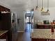 Open kitchen featuring tile floors, granite countertops, and stainless steel refrigerator at 4683 Derby Loop, Fairburn, GA 30213