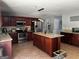 Updated kitchen featuring granite countertops, tile floors, and a kitchen island at 4683 Derby Loop, Fairburn, GA 30213