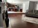 Spacious living room with fireplace, hardwood floors, and an open view into the kitchen at 4683 Derby Loop, Fairburn, GA 30213