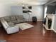 Comfortable living room with fireplace, hardwood floors, and a large sectional sofa at 4683 Derby Loop, Fairburn, GA 30213