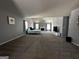 Open living room with neutral carpet, vaulted ceilings, and fireplace for relaxed living at 4683 Derby Loop, Fairburn, GA 30213