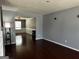 Spacious living room with hardwood floors, neutral paint, and ample natural light at 4683 Derby Loop, Fairburn, GA 30213