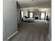 Spacious living room area with bed, fireplace, ceiling fan and light gray color scheme at 4683 Derby Loop, Fairburn, GA 30213