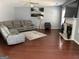 Cozy living room featuring a fireplace, hardwood floors, and a comfortable sectional at 4683 Derby Loop, Fairburn, GA 30213