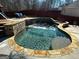 Beautiful pool with stone accents, featuring a waterfall and slide for summertime fun at 4683 Derby Loop, Fairburn, GA 30213