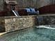 This inviting pool features a stone surround with a gentle waterfall feature and outdoor seating at 4683 Derby Loop, Fairburn, GA 30213
