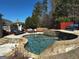 Beautiful pool area with lush landscaping, stone accents and outdoor furniture at 4683 Derby Loop, Fairburn, GA 30213