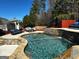 Backyard with a large swimming pool, outdoor seating area, and lush green trees at 4683 Derby Loop, Fairburn, GA 30213