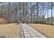 Spacious backyard featuring a stone pathway and fire pit at 133 Vivian Ln, Peachtree City, GA 30269