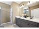 Bathroom featuring double sink vanity, modern fixtures, and a glass-enclosed shower at 10465 Trellis Lane (Lot 26), Hampton, GA 30228