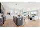 Open kitchen with a large island, modern appliances, seamlessly connected to the living area at 10465 Trellis Lane (Lot 26), Hampton, GA 30228
