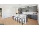 Modern kitchen with an island, stainless steel appliances, sleek countertops, and ample cabinet space at 10465 Trellis Lane (Lot 26), Hampton, GA 30228