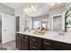 This bathroom features a double sink vanity with a large mirror and a glass enclosed shower at 10471 Trellis Lane (Lot 25), Hampton, GA 30228