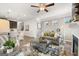 Open living area with a fireplace, ceiling fan, and view into the adjacent kitchen and dining space at 10471 Trellis Lane (Lot 25), Hampton, GA 30228