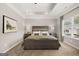 This main bedroom features a tray ceiling, a large bed and two end tables with lamps at 10471 Trellis Lane (Lot 25), Hampton, GA 30228