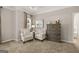 This sitting area features two upholstered chairs, a decorative chest, and a window with curtains at 10471 Trellis Lane (Lot 25), Hampton, GA 30228