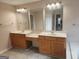 Bathroom featuring double sinks with wooden cabinets and large mirrors, blending functionality with style at 2765 Turning Leaf Dr, Lawrenceville, GA 30044