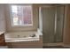 Bright bathroom with a jacuzzi tub and a walk-in shower, offering a luxurious and functional space at 2765 Turning Leaf Dr, Lawrenceville, GA 30044