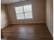 Cozy bedroom with wood-look floors and a window that lets in natural light at 2765 Turning Leaf Dr, Lawrenceville, GA 30044