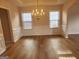 Classic dining room featuring hardwood floors, chair rail, and a stylish chandelier, ideal for formal gatherings at 2765 Turning Leaf Dr, Lawrenceville, GA 30044