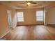 Spacious main bedroom featuring hardwood floors, tray ceiling, and ample natural light, creating a luxurious retreat at 2765 Turning Leaf Dr, Lawrenceville, GA 30044
