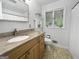 Bright bathroom featuring a granite vanity top, modern fixtures, and a window at 102 Pinegate Rd, Peachtree City, GA 30269