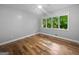 Bright bedroom features hardwood floors, a large window, and a tranquil atmosphere at 102 Pinegate Rd, Peachtree City, GA 30269