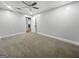 Bedroom with plush carpeting and a door leading to an unseen hallway with wood-look floors at 102 Pinegate Rd, Peachtree City, GA 30269