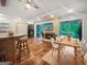Dining room with fireplace, hardwood floors, access to deck, and adjacent kitchen at 102 Pinegate Rd, Peachtree City, GA 30269