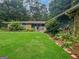 Charming home exterior with a well-manicured lawn and colorful flowerbeds in landscape at 102 Pinegate Rd, Peachtree City, GA 30269
