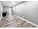 Hallway view with plank flooring leading to office area featuring gray walls and bright lighting at 102 Pinegate Rd, Peachtree City, GA 30269