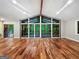 Bright living room with vaulted ceilings, exposed beams, hardwood floors and access to a screened-in porch at 102 Pinegate Rd, Peachtree City, GA 30269
