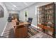 Basement office features a desk, bookcase, and sliding glass door at 102 Pinegate Rd, Peachtree City, GA 30269