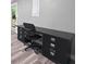 Office area featuring a built-in black desk and shelving unit with modern chair and wood-look flooring at 102 Pinegate Rd, Peachtree City, GA 30269