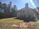 Side view of home shows brick accents and large backyard, mature trees surround property at 276 Arborview Dr, Mcdonough, GA 30252